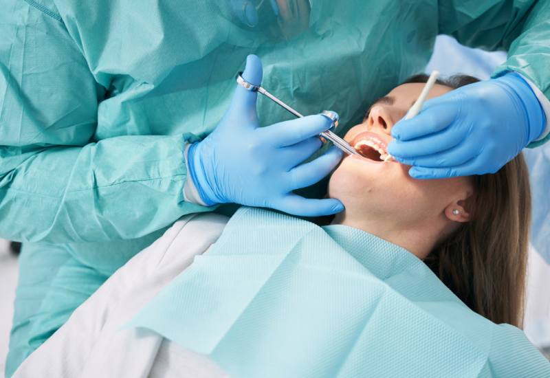 Woman receiving dental treatment in dentist office